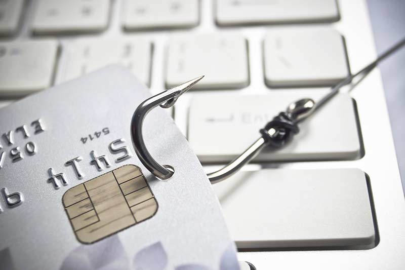 A fishhook going through a credit card - "phishing"